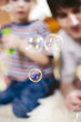 Father and son blowing bubbles