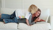 Woman being joined by her son as she uses a laptop