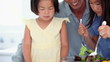 Family working together as they prepare a salad