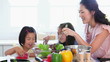 Family work together to make a salad