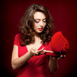 Happy girl opening a gift on Valentine's Day