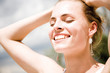 Young woman smiling, eyes closed