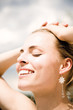 Young woman smiling, eyes closed