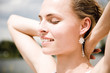 Young woman smiling, eyes closed