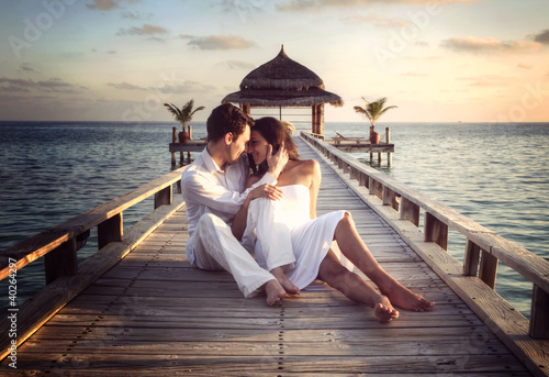 Photo: Sensual happy couple with white clothes on a pier (Maldives) Sensual happy couple with white clothes on a pier (Maldives)