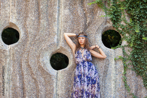 Photo: Woman in a sundress at the stone wall Woman in a sundress at the stone wall