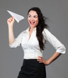 Beautiful smiling woman holding a paper airplane Beautiful smiling woman holding a paper airplane