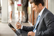 Businessman using laptop, side view