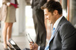 Businessman using laptop, side view