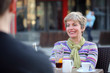 Photo: People in cafe, smiling mid adult woman People in cafe, smiling mid adult woman