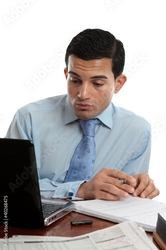 Photo: Businessman at desk working Businessman at desk working