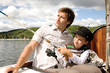 Father with son holding fishing rod