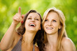 Two youngl pretty women in a park