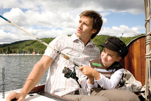 Photo: Father with son holding fishing rod Father with son holding fishing rod