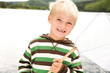 Boy holding fishing net, smiling, portrait