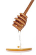Honey dripping from a wooden spoon