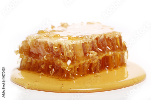 Photo: Honey dripping from a wooden spoon Honey dripping from a wooden spoon
