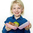 Cute girl shows her sandwich eaten during break