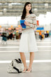 Young woman holding brochure at airport