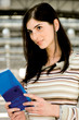 Young woman holding brochure at airport