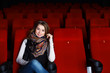 Young girl in cinema watching movie