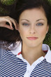 Young woman lying on grass, portrait