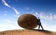 Businessman rolling a giant stone
