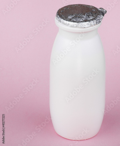 Photo: white bottle on pink background white bottle on pink background