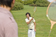Friends playing badminton in park