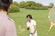 Friends playing badminton in park