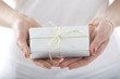 Young lady with small present in her hands