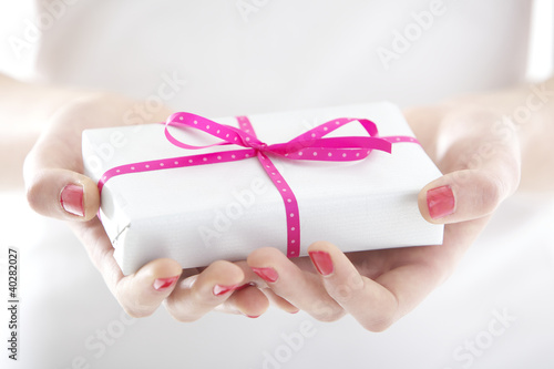 Photo: Hands holding beautiful gift Hands holding beautiful gift