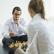 Mid adult couple playing chess, side view