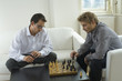 Mid adult men playing chess