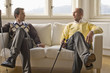 Men holding golf clubs, conversing
