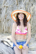 woman sitting on beach wearing hat woman sitting on beach wearing hat
