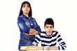 Boy studying under strict supervision