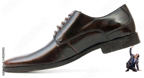 Photo: Woman domination concept with shoes and man Woman domination concept with shoes and man