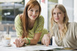 Photo: Young women at cafe, smiling, portrait Young women at cafe, smiling, portrait