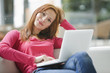 Young woman using laptop, portrait