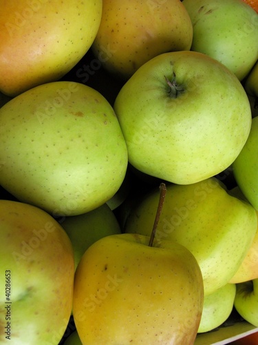 Photo: Apples in a box at the greenghrocer on the market place Apples in a box at the greenghrocer on the market place