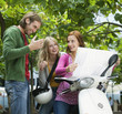 Young women sitting on motor scooter, smiling