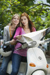 Young women holding map