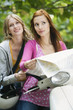 Young women holding map