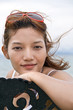 Young woman sitting on a bench by the sea..