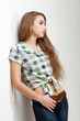 young woman wearing jeans near wall