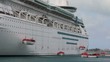Modern cruise ship deploying lifeboats during a safety drill