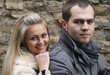 Young Woman Smiling From Behind Her Boyfriend Young Woman Smiling From Behind Her Boyfriend