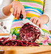 Woman's hands cutting red cabbage
