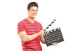 A smiling man holding a movie clap A smiling man holding a movie clap